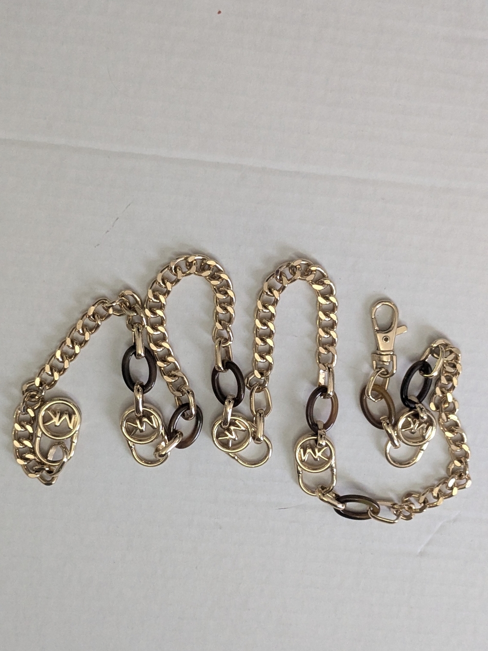 Michael Kors chain belt featuring metal links and an MK logo clasp. 39"